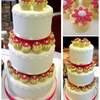 daisy wedding cake with mini cupcakes